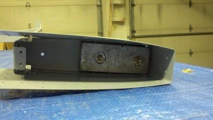 Counterbalance weight bolted onto the counterbalance rib