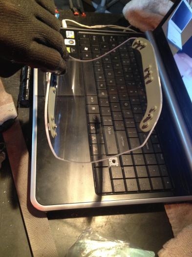 Placing retainer strips on trimmed Plexiglass lens using thin double sided tape