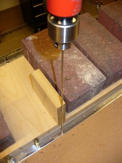 Trailing edge being drilled, using old wood guide from empennage.