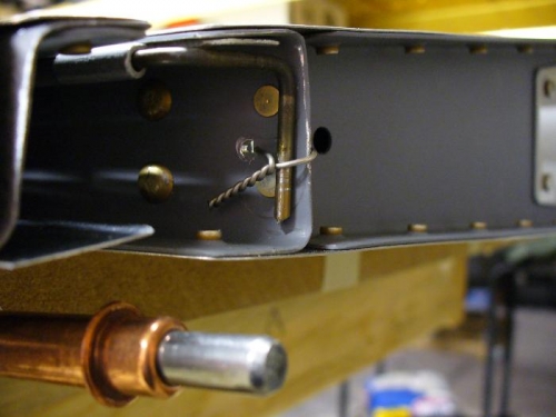 closeup of hinge wire bent to spar and safety wired
