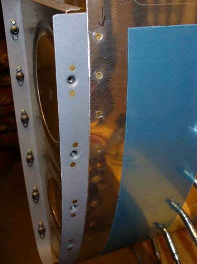 Finished rivets and W-919 splice plate with nutplates attached where tank will fasten
