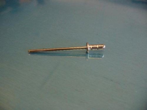 Close-up of a blind rivet with pulling pin most of length.