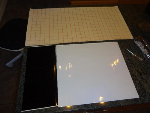 One sheet of cut black vinyl letters, one sheet of cut white vinyl letter,  and one sheet of transfer