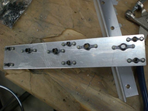 Nutplates installed on backing plate.