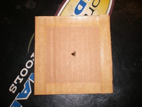 Cardboard with sticky tape and nail