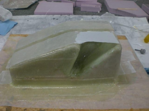 Laying fiberglass on the mold