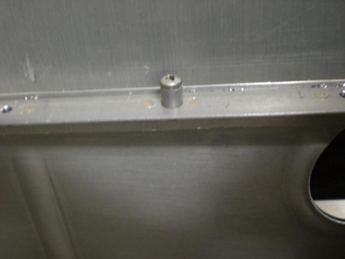 Nutplate held in to rivet