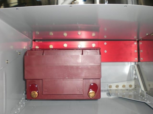 Baggage sidewall and battery mount