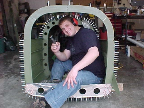 Josh is happy the last rivet in F-1075 is done. It's a tight fit back there!
