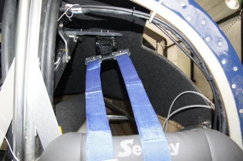The seat belt retractor connected to the harness