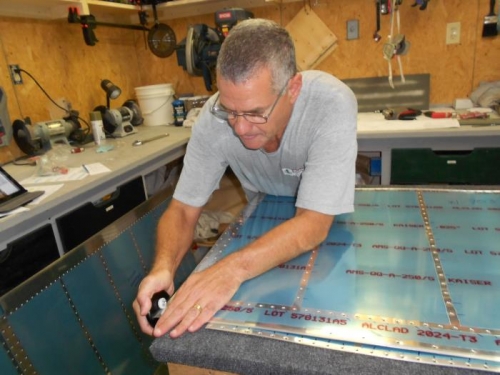 Dan rolling the edges of the upper and lower outboard wing skins