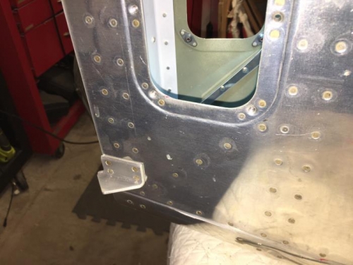 riveted in - see diagonal rivets/part under access hole