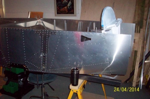 The right front fuselage skin riveting complete.