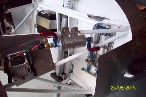 Fine fuel filter and fuel pressure sensor attached to upper-left engine mount arm.