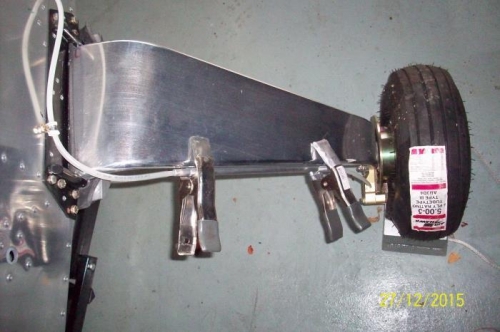 Brake line mount clamped into position while molding tape cures.