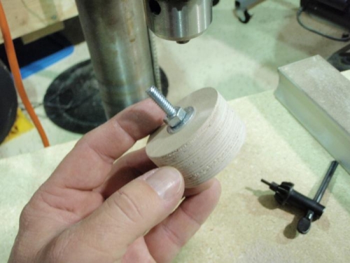 Sanded discs on bolt that was inserted in drill press