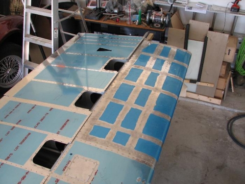 Starboard wing upside down, tank installed, lower skins resting on the wing.