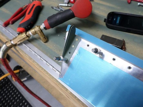 Riveting the trim cable brackets