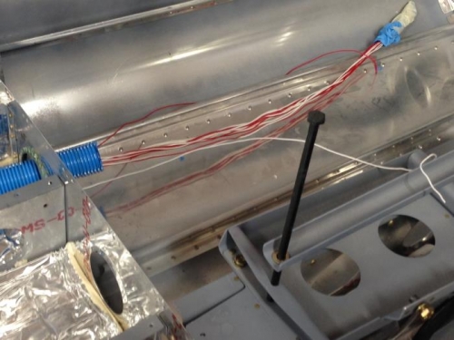 Conduit from empennage to baggage floor