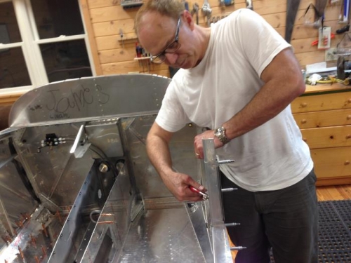 Preparing to rivet floor pans