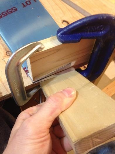 Using wood to fold the other end of the trim tab.