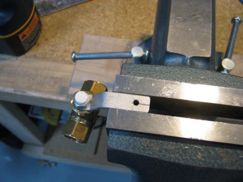 Drilled mounting hole for fuel valve shutoff handle assembly