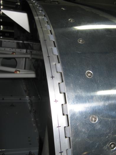 Upper cowling hinge with hole locations identified.