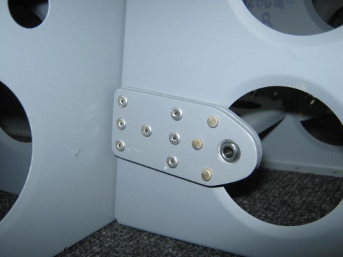 Rivet the F1206f bearing bracket brace to the F1206g baggage ribs