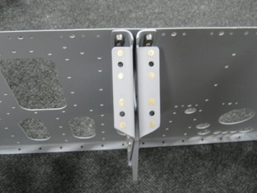 Installed nut plates on left & right control column assembly upper flange