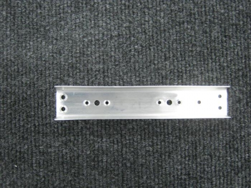 Cut apart and deburred F1257 rudder pedal support panels and dimpled corresponding holes