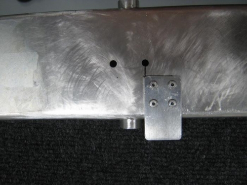 Position and attach latch handle stop to canopy frame