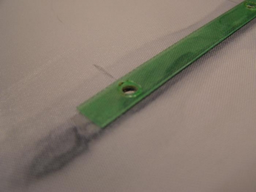 lexan strip to hold fabric to rib