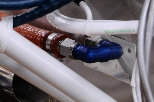 Closeup Of AN Fitting On Firewall With Hose Attached