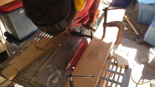 My son using his vernier caliper to afjust the fence on our table saw.