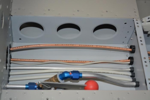 around the rudder pedals and past the fuel shut off valve