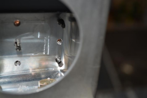 Backside view of clamps securing roll bar against base