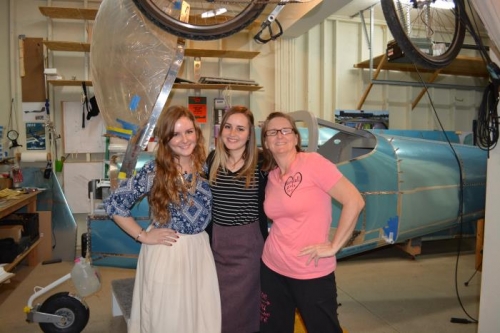 Cyndi with the Sis Missionaries and plane in background