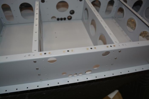 Nut plates attached to upper flange of bukhead