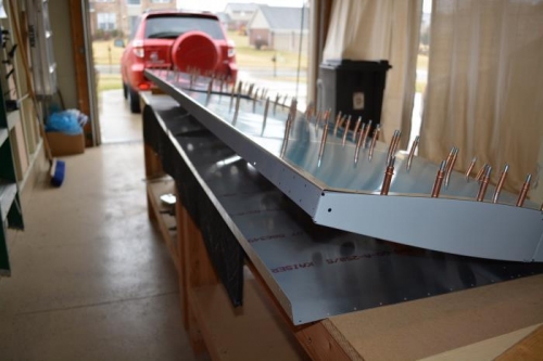 Stabilator aft flange painted and one side clecoed in place