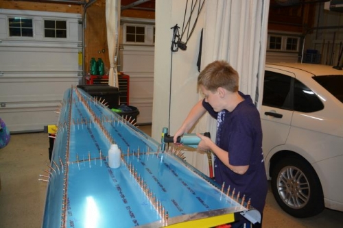 Benjamin helping set rivets