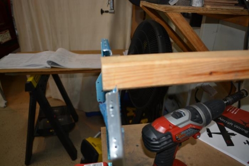 Used hack saw to cut a slot in wood and attached other end to wall stud