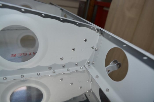 Right outboard hinge bracket revited in place