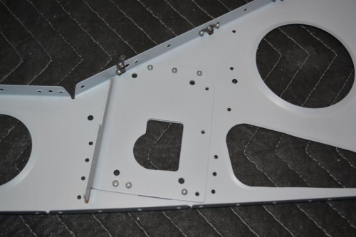 Bracket rivted to seat rib