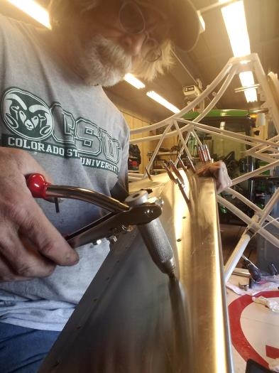 Initial riveting of trim fins