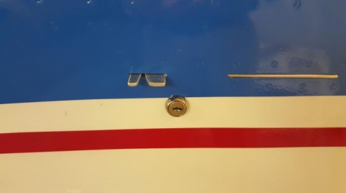 Canopy latch system including a key lock matching the ignition