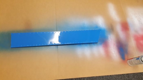 trim tab on a piece of cardboard for touchup painting