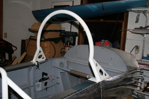 Here's the windshield bow bolted in place via the inboard 2 bolts on each side (note the clamp)