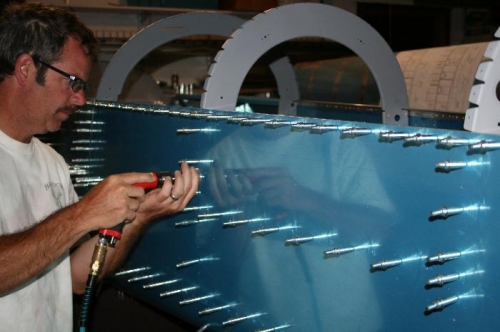 Drilling out the bulkhead to aft side skin holes per the plans.