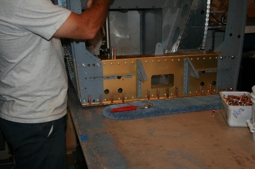 Squeezing the nutplate rivets that go through the mid cabin braces to the center section.