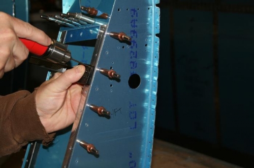 Using a nutplate jig to drill the nutplate rivet holes.